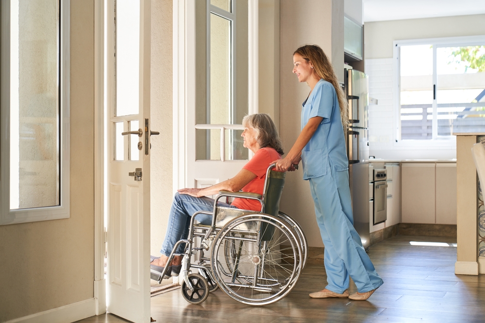 Caregiver,Or,Nurse,Pushes,A,Paralyzed,Elderly,Woman,In,A