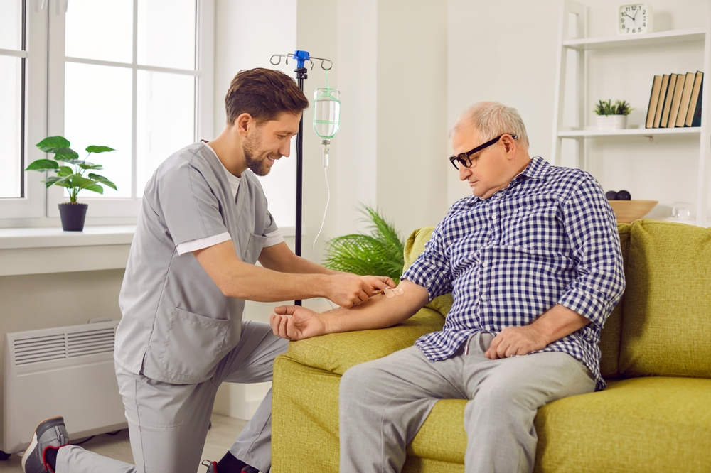 Doctor,Gives,Intravenous,Infusion,To,Senior,Patient.,Young,Nurse,In